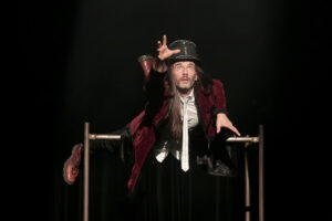 Le comédien lance son bras loin devant lui.