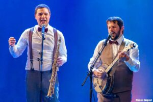 Deux musiciens sont l'un à côté de l'autre.